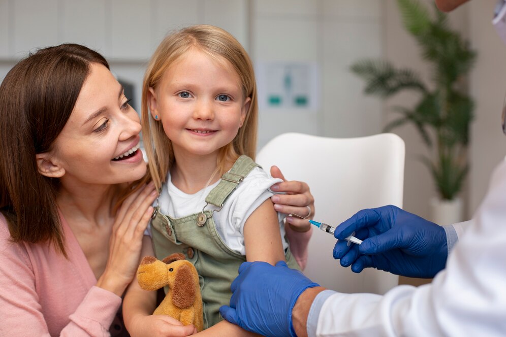 Young boy receiving a vaccination shot from a healthcare professional in a clinical setting.